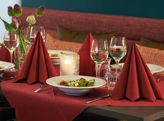 Red Dunilin® linen feel napkins on set restaurant table for Christmas